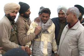 The resident of Muthianwali village (with a cloth round his neck), who climbed on an overhead water tank in Fazilka on Friday.