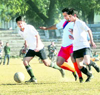 Players vie for the ball in a match of the Great Vivekanand Memorial Football Tournament in progress in Dehradun on Friday