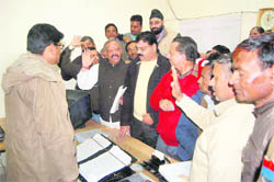 Congress workers present a memorandum to the Chief Executive Officer of the Dehradun Municipal Corporation