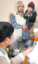 Satish Kumar with his child at the office of the DC.