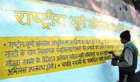 Even as Dogri, Punjabi and Urdu are Jammus official languages, a painter paints some information regarding land records in shuddh Hindi. 