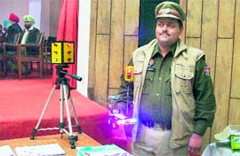 Inspector Pardeep Sandhu, SHO (Traffic), shows the movable traffic lights, during a road safety week in Ludhiana on Friday.