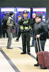 A police officer patrols King's Cross train station in London on Friday.