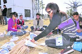 Volunteers prepare flags and buntings for the SAF Winter Games in Dehradun on Saturday.
