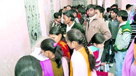 Students queue up at the fee counter of DAV PG College in Dehradun on Saturday.