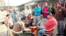 Income Tax officials during a raid on wholesellers of onions at a Dehradun mandi on Saturday.