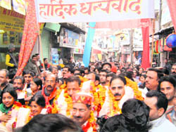 Members of the newly elected Municipal Council being welcomed by supporters during a victory rally in Kangra
