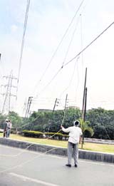 Power corporation employees lay cables near the Ferozepore road