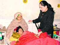 A doctor enquires about Pujas health; and (top left to right) Ravinder Kaur and Paramjit Kaur, both nurses at the Civil Hospital, who looked after Puja in Ludhiana