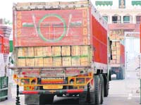 Trucks carrying tomatoes cross over to Pakistan at the Attari-Wagah checkpost on Saturday. 