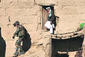 A French soldier, along with unseen members of the Afghan National Police, during a house-to-house search in Jalokhel in Kapisa province of Afghanistan  Photo: AFP