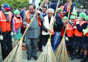 Delhi finance minister A.K. Walia takes part in a cleanliness campaign at R. K. Puram in New Delhi