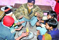 People sit around a bonfire in Haridwar on Sunday