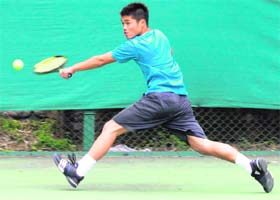 A tennis player returns a shot during a match at the CLTA in Chandigarh