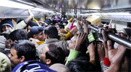 An overcorwded Metro train on the HUDA City Centre- Jahangirpuri Line in New Delhi on Monday.