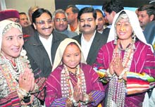 Uttarakhand Chief Minister Ramesh Pokhriyal Nishank and Union Minister of State for Youth Affairs and Sports Prateek Prakashbapu Patil with tribeswomen from Gunji of Pithoragarh district at the opening ceremony of the SAF Winter Games in Dehradun on Monday. 