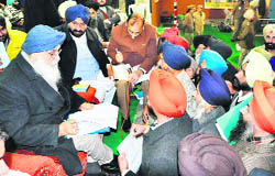Chief Minister Parkash Singh Badal interacts with members of village panchayats during a sangat darshan programme at Doraha on Monday.