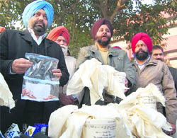 Police personnel display packets of heroin seized from a smuggler in Amritsar on Monday.