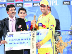 Chennai Super Kings captain MS Dhoni (R) with the IPL 3 winners trophy.