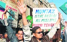 Supporters of Sunni Tehreek chant slogans during a rally in support of Mumtaz Qadri in Hyderabad on Monday. 