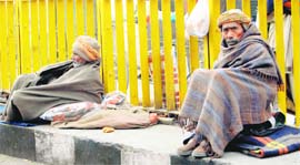 Poor people spend their days on a pavement with just blankets to protect themselves from bone-biting weather in Amritsar.