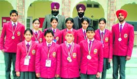 Students of Dasmesh Parivar International School pose with their medals, won at the Indo-Nepal International Table Soccer Championship, in Amritsar.