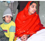 Khushpreets mother Kulwinder with her son Inder at their home at Burail village in Chandigarh