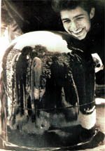 A devotee looks at his image in the Shivalingam at Lakhamandal
