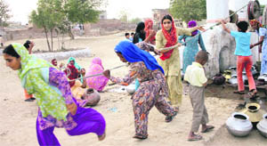 Women draw water from a well outside Igrah village in Jind district.
