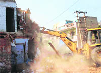 A structure being razed in Ballabgarh on Tuesday.