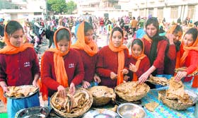 Students of PMG Nursing College distribute langar on Gurpurb at Gurdwara Singh Sabha, Model Town, in Jalandhar on Tuesday.