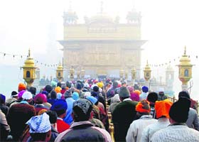Devotees await their turn to pay obeisance at the Golden Temple on the birth anniversary of Guru Gobind Singh