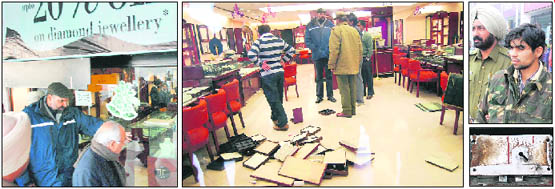 SSP Naunihal Singh and IGP PK Srivastava enter the Tanishq Jewellers showroom in Mani Majra; Make-or-Break Time: Police officials inspect the crime scene as jewellery boxes lay scattered; Guards down: Showroom security guard Sawran Singh being taken away by the police; and Unlocking the Mystery: The shutter lock that was cut open using a gas welder by the robbers on Wednesday.