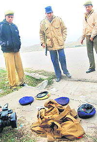 Cops inspect police uniforms left by the robbers after the crime near the showroom at Mani Majra on Wednesday. 