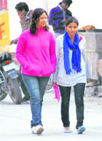 Two girls have a walk as Haridwar witnessed one of the coldest days of this season on Thursday