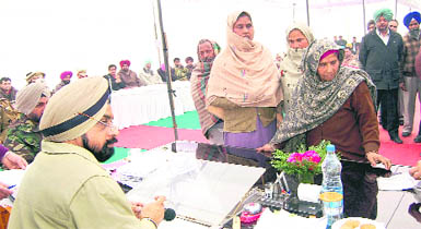 Police Commissioner Parampal Singh Sidhu listens to public grievances during a police-public hearing in Amritsar on Wednesday.