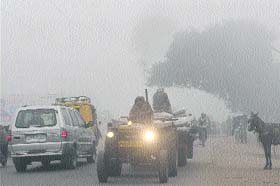 BRAVING THE CHILL: Commuters face a tough time on a foggy morning in Amritsar