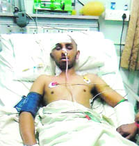 Tarun Sharma, who was attacked by an NRI son of a political leader, undergoes treatment at a hospital in Ludhiana.