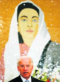 Biden speaks in front of a portrait of Benazir Bhutto in Islamabad