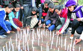 Students light candles for Save the girl child before Lohri celebrations at Panjab University on Thursday.