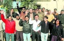 Congress workers hold a protest in Dehradun on Thursday