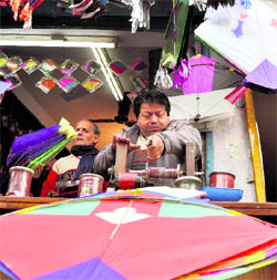 A shopkeeper rolls dor on a roller