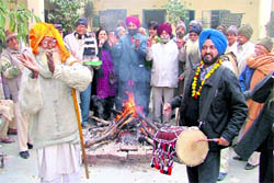 Members of New Hope, an NGO, celebrate Lohri with inmates of Swami Vivekananda Ashram in Ludhiana on Thursday
