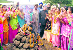 Girls dance and sing folk songs around a bonfire during a state-level function organised at Guru Nanak Dev Bhawan in Ludhiana on Thursday