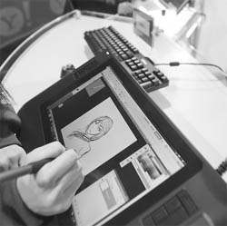 A visitor tries out a Wacom Bamboo Pen &Touch tablet during the 2011 International Consumer Electronics Show in Las Vegas, USA.