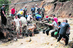 Rescue workers search for victims after heavy rains caused mudslides in Teresopolis on Wednesday.