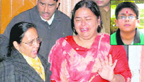 Mother of the missing child (inset) in tears at the Sector 22 police station on Friday.