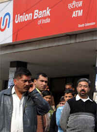 People gather outside the bank in south Delhi where the robbery took place on Friday. 