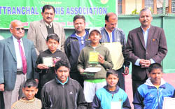 Winners of various titles at the All-India Talent Series Lawn Tennis Tournament pose with officials in Dehradun