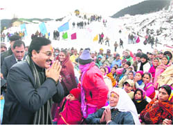 Uttarakhand Chief Minister Ramesh Pokhriyal Nishank greets local residents at the opening ceremony of the skiing leg of the SAF Winter Games at Auli in Chamoli district 